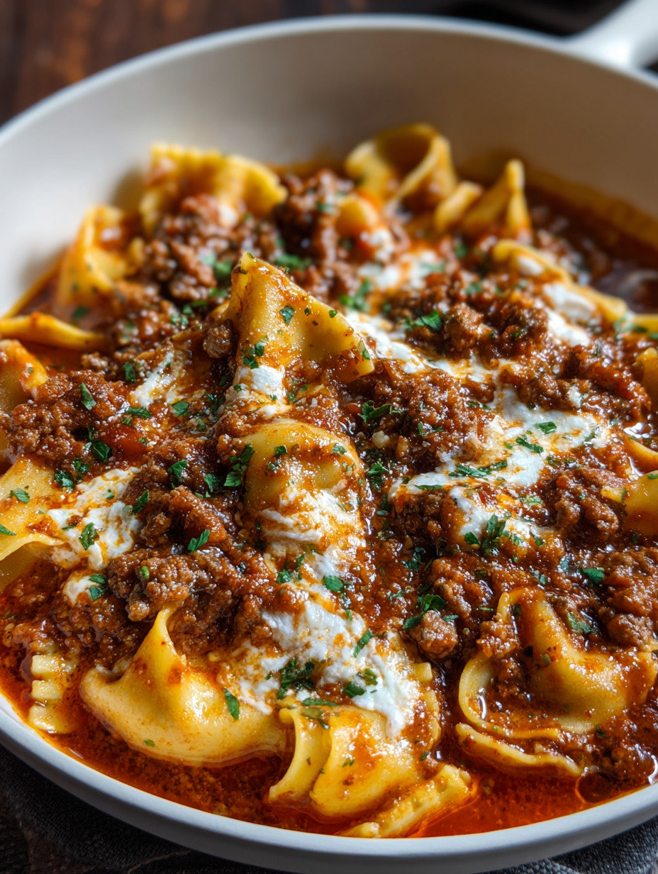 A bowl of lasagna soup with pasta and meat.