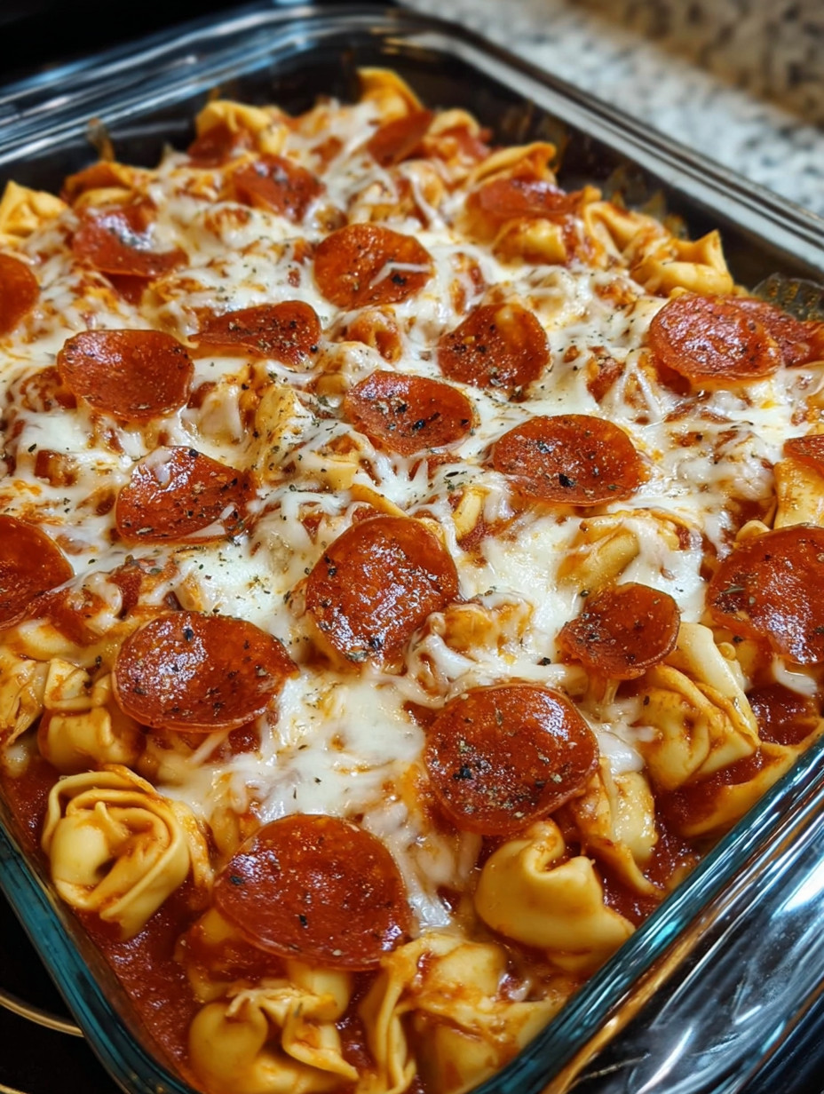 A dish of pasta with pepperoni and cheese.