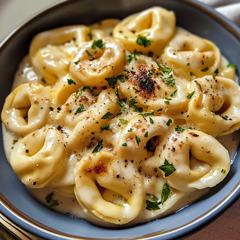 A bowl of pasta with cheese and herbs.