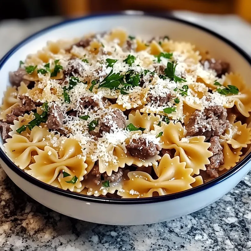 A bowl of pasta with meat and cheese.