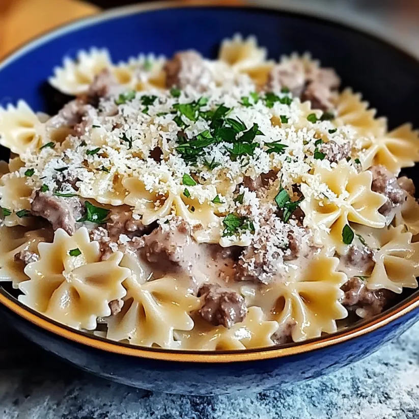 A bowl of pasta with garlic and Parmesan cheese.