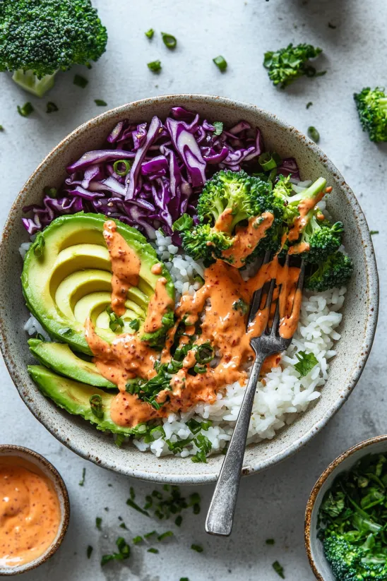 A bowl of food with broccoli and rice.