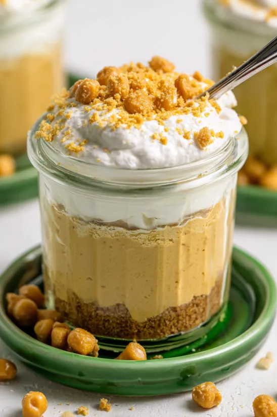 A close up of a dessert in a glass jar.