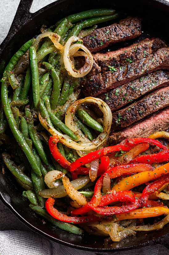 A plate of food with a steak fajita.