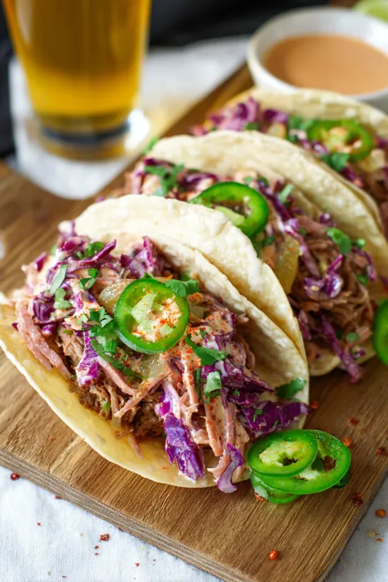 A plate of corned beef tacos with a creamy cabbage slaw.