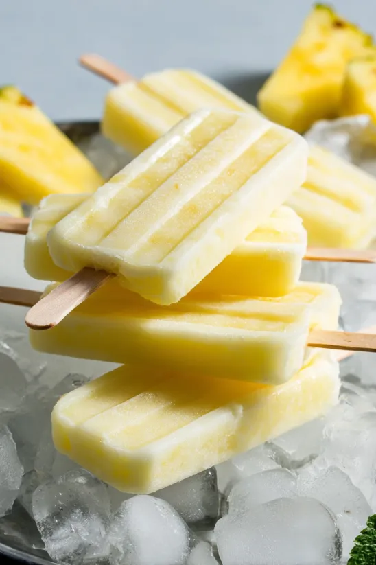 Dole Whip Popsicles are stacked on top of each other.