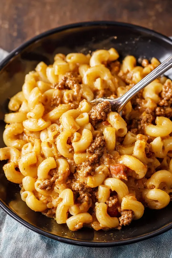 A bowl of Hamburger Helper with a spoon in it.