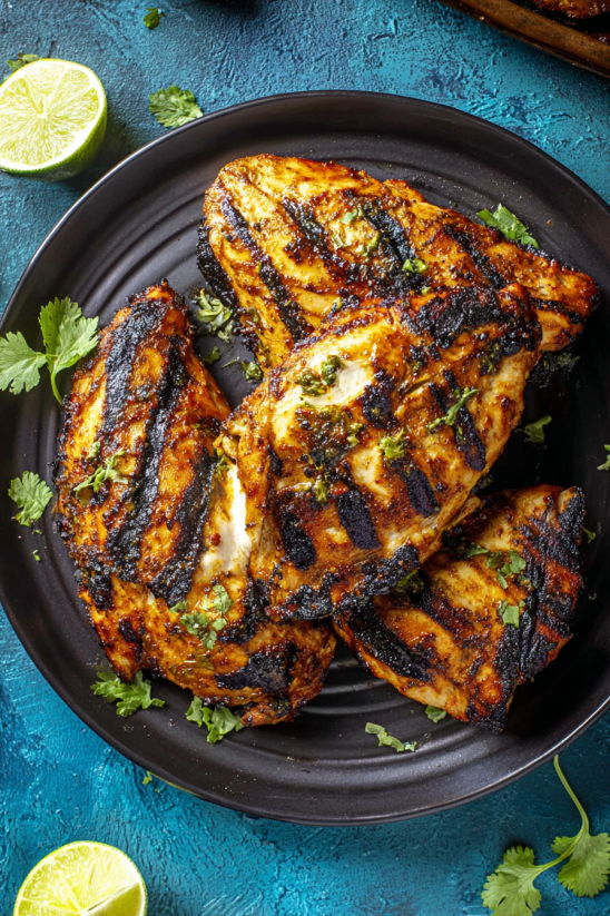A plate of chicken with a harissa sauce.