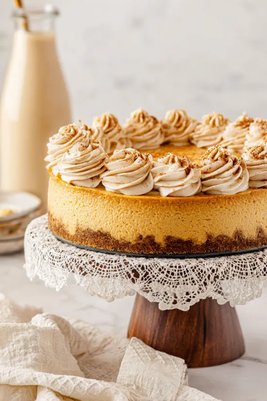A slice of pumpkin cheesecake on a doily.