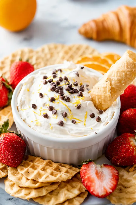 A bowl of cannoli dip with a waffle cone.