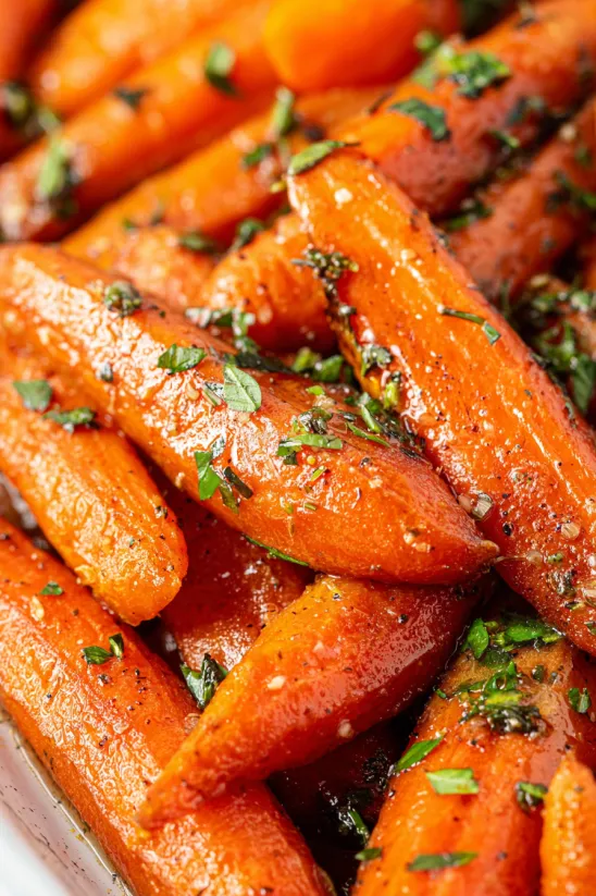 A close up of candied carrots.