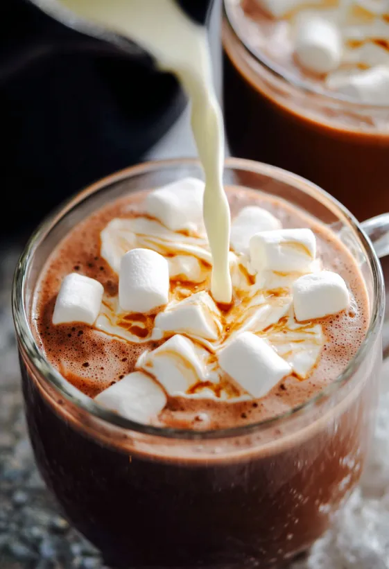A glass of hot chocolate with marshmallows in it.