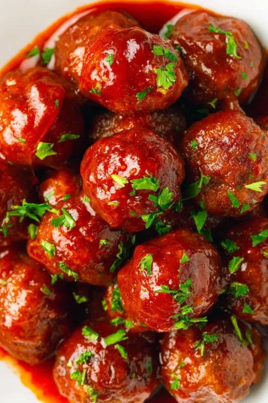 A close up of meatballs in a sauce.