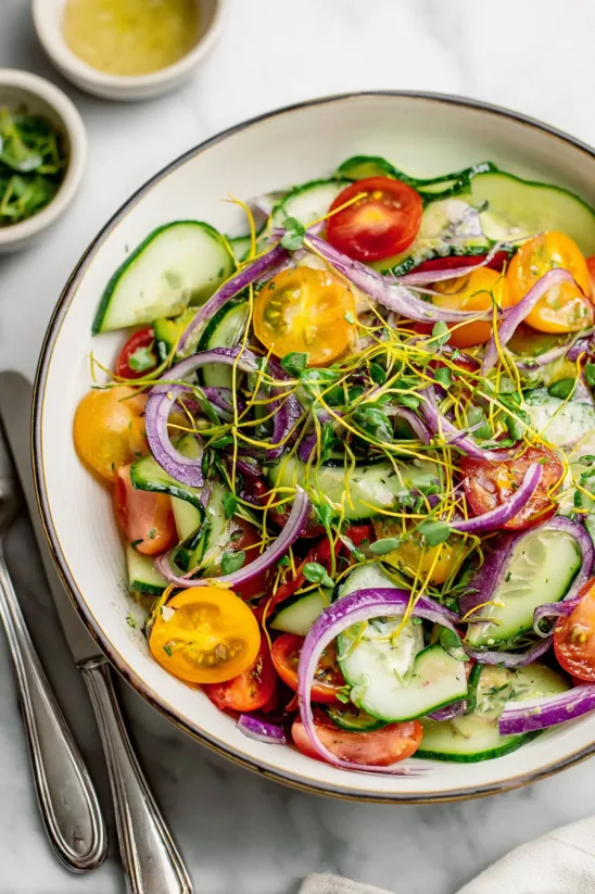 A bowl of cucumber tomato salad.