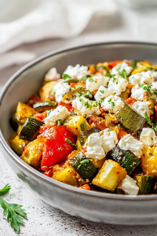 A dish of Mexican squash with cheese and tomatoes.
