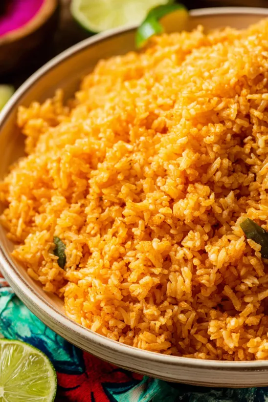A bowl of rice with a green pepper on top.