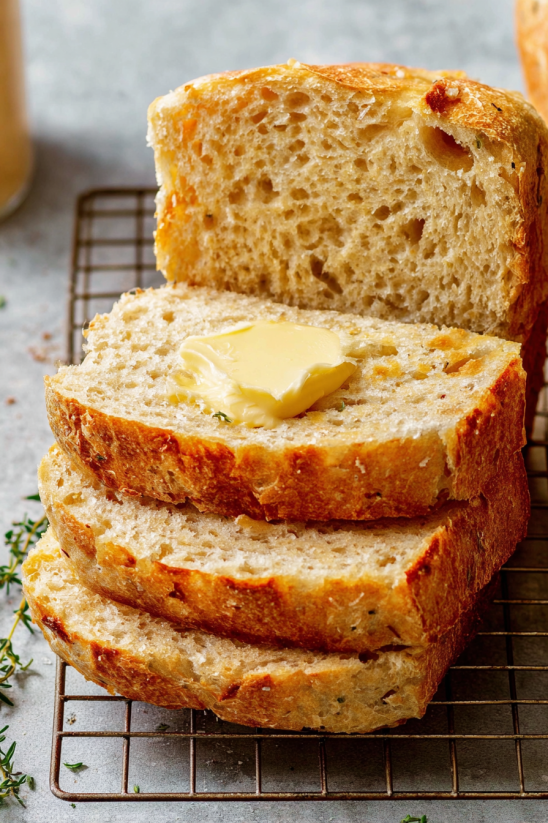 A loaf of bread with butter on top.