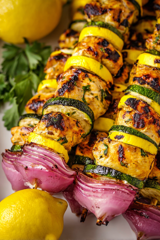 Grilled chicken kabobs with onions and lemon.