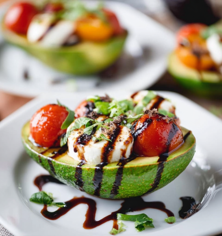 A Caprese stuffed avocado with tomatoes and cheese.