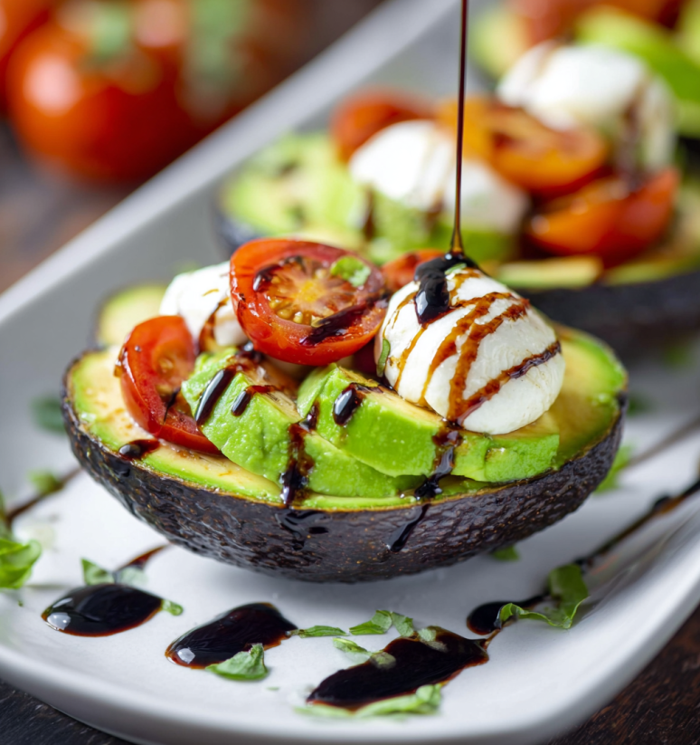 A Caprese stuffed avocado with tomatoes and cheese.
