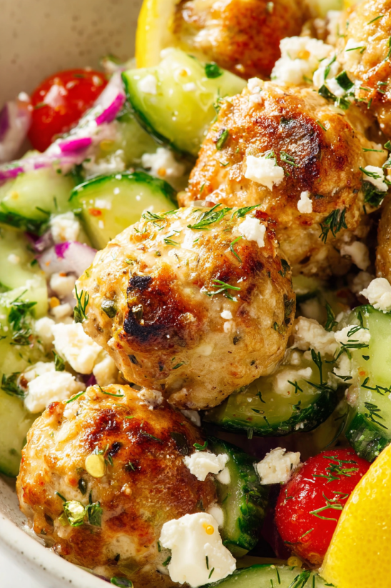 A plate of Greek chicken meatballs with vegetables.