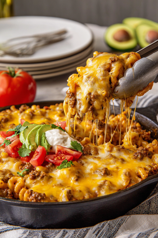 A taco mac and cheese dish being served.