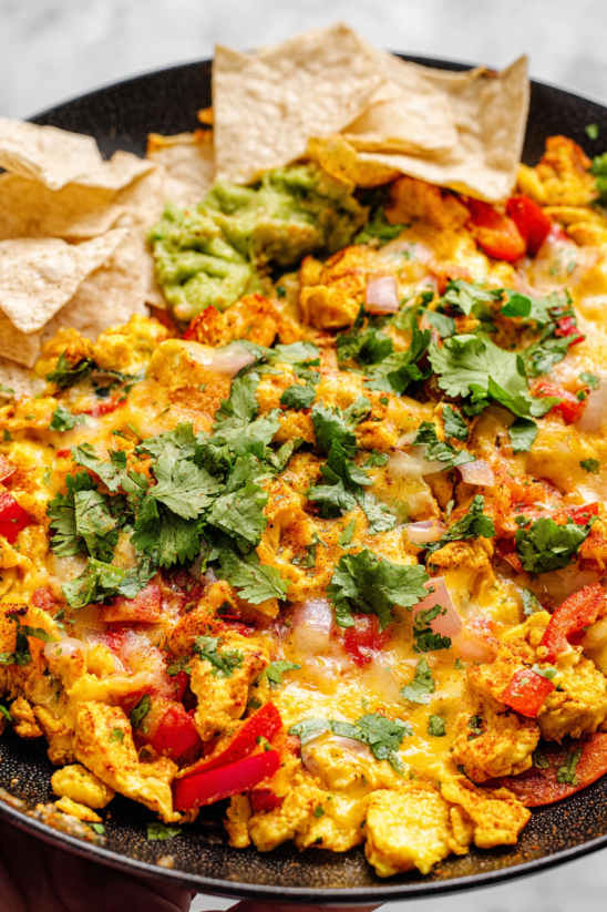 Migas with tomatoes, onions, and avocado.