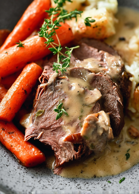 A delicious looking pot roast with mushrooms and carrots.