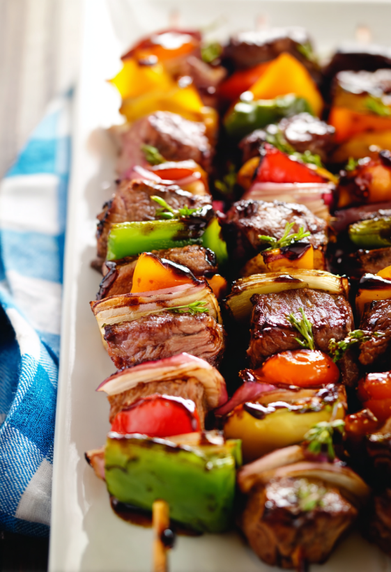 Grilled steak kebabs with various vegetables.