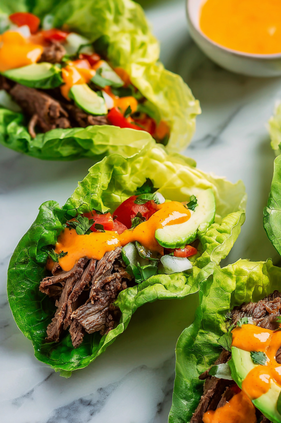 A salad with lettuce, tomatoes, and meat.
