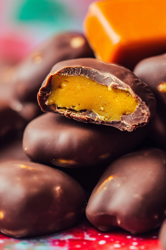 A piece of chocolate candy with a yellow center.