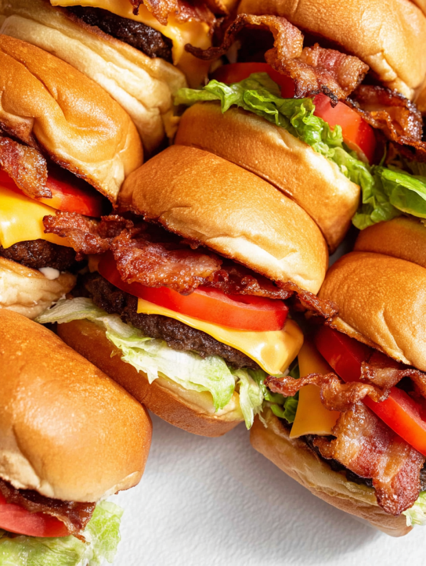 A stack of bacon cheeseburger sliders.