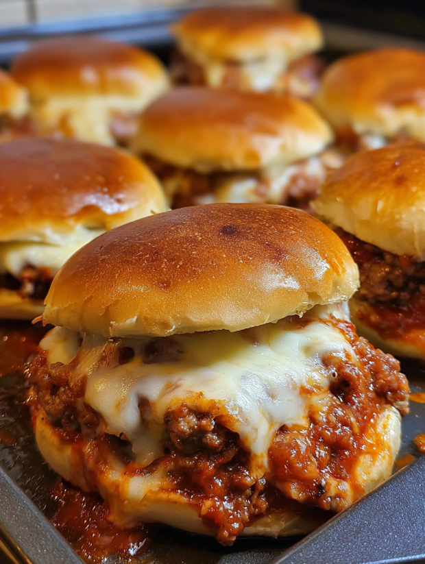 A plate of cheesy pizza burgers.
