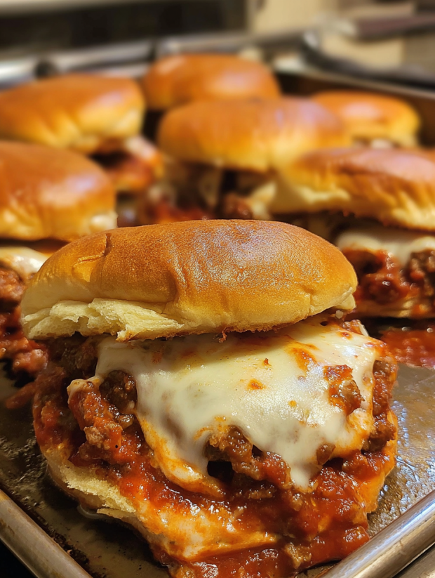 A close up of a cheesy pizza burger.