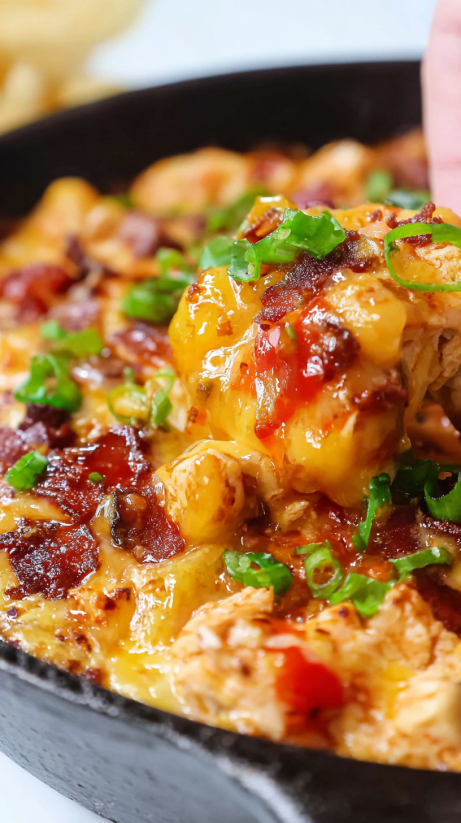 A close up of a cheesy barbecue chicken dip.