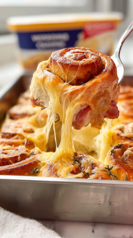 A slice of ham and cheese pizza rolls.