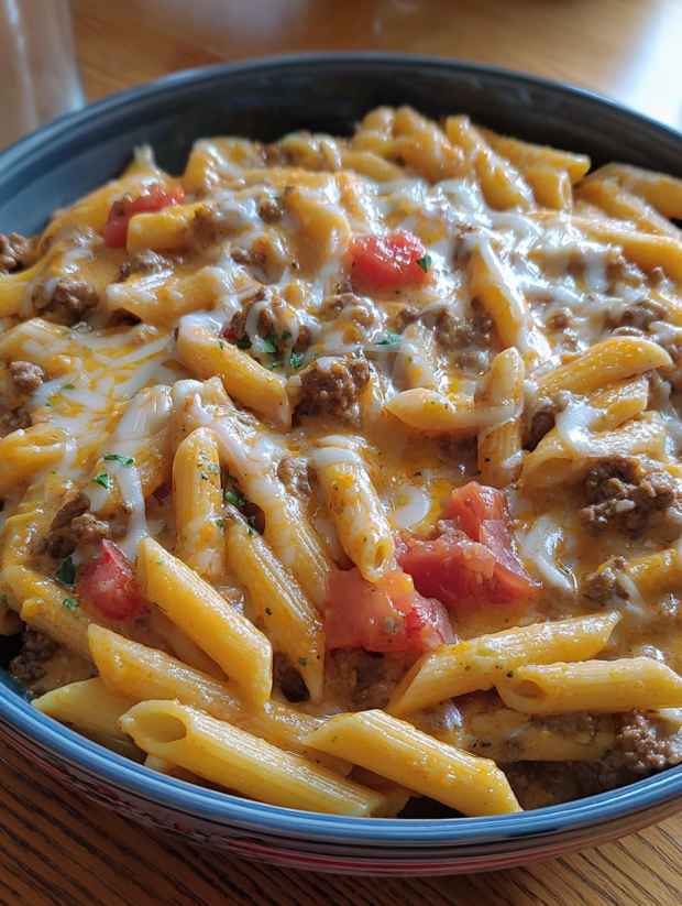 A bowl of pasta with cheese and tomatoes.