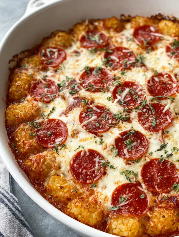 A close up of a pepperoni pizza tater tot casserole.