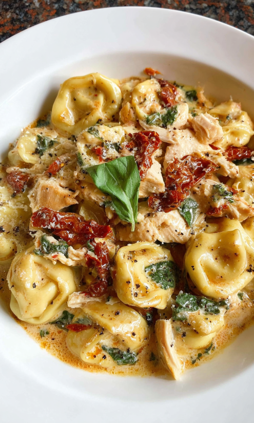 A plate of food with chicken and pasta.