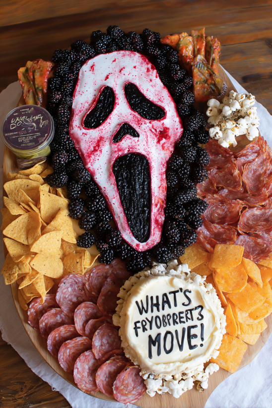 A Halloween charcuterie board with a screaming face.