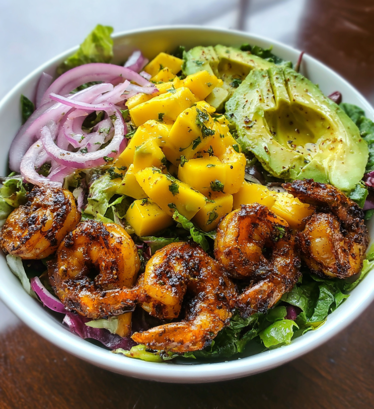 A bowl of shrimp, avocado, and mango.