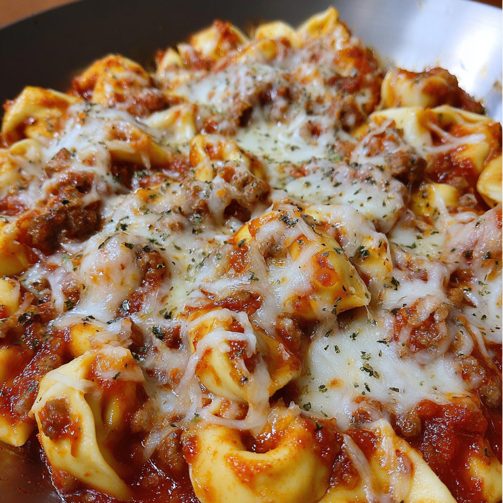 A close up of a cheesy sausage tortellini.
