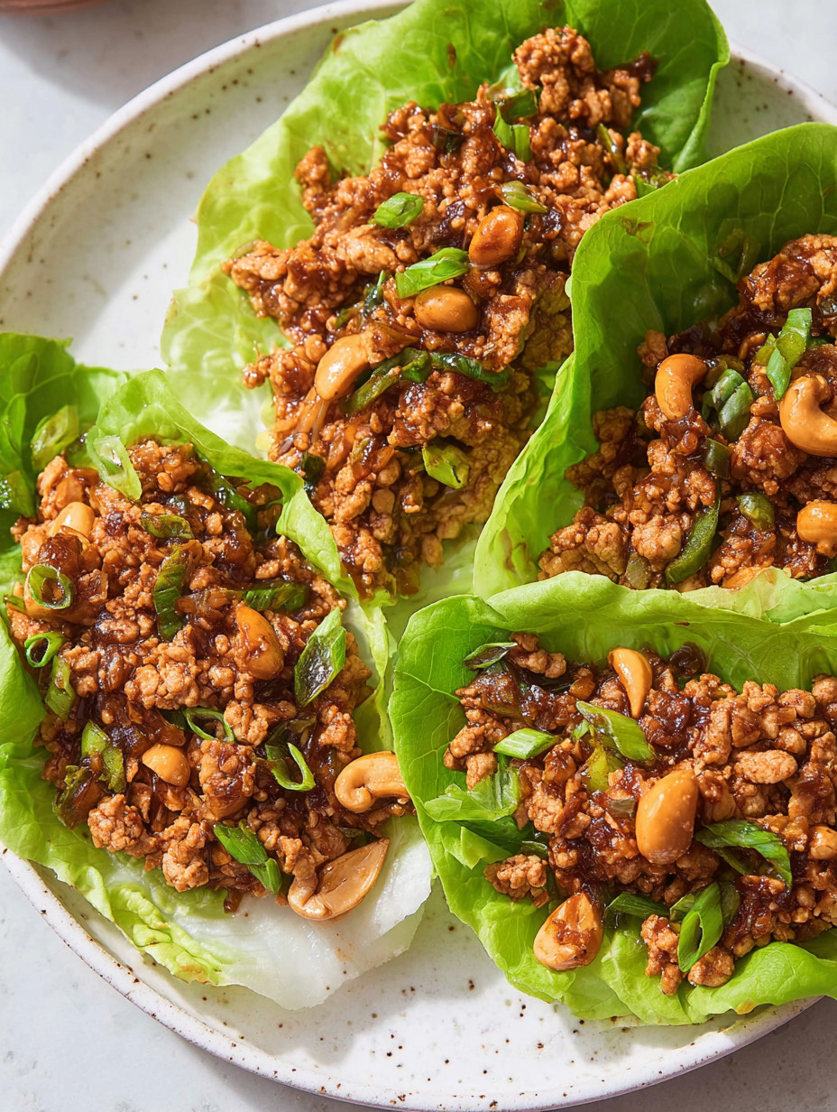 A plate of food with lettuce wraps and meat.
