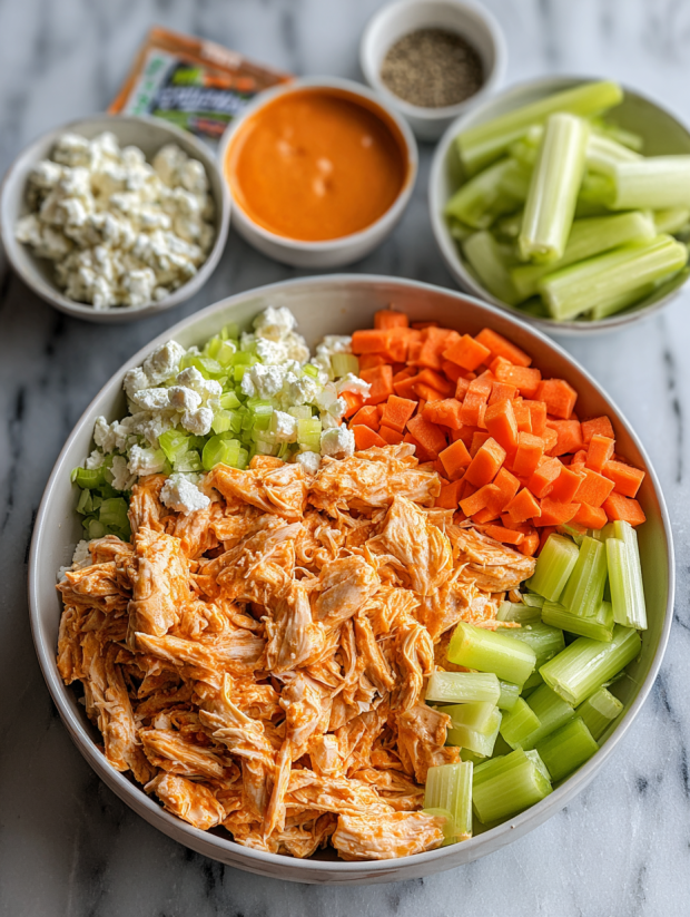 A bowl of chicken salad with various vegetables.