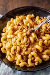 A bowl of Hamburger Helper with a spoon in it.