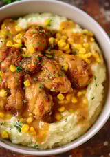 A bowl of chicken and mashed potatoes.