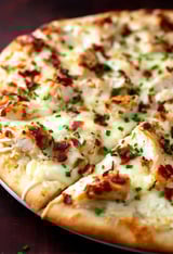 A slice of chicken Alfredo pizza.