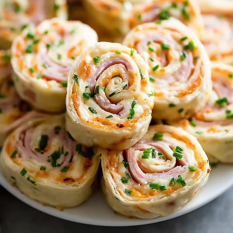 A plate of ham and cheese pinwheels.